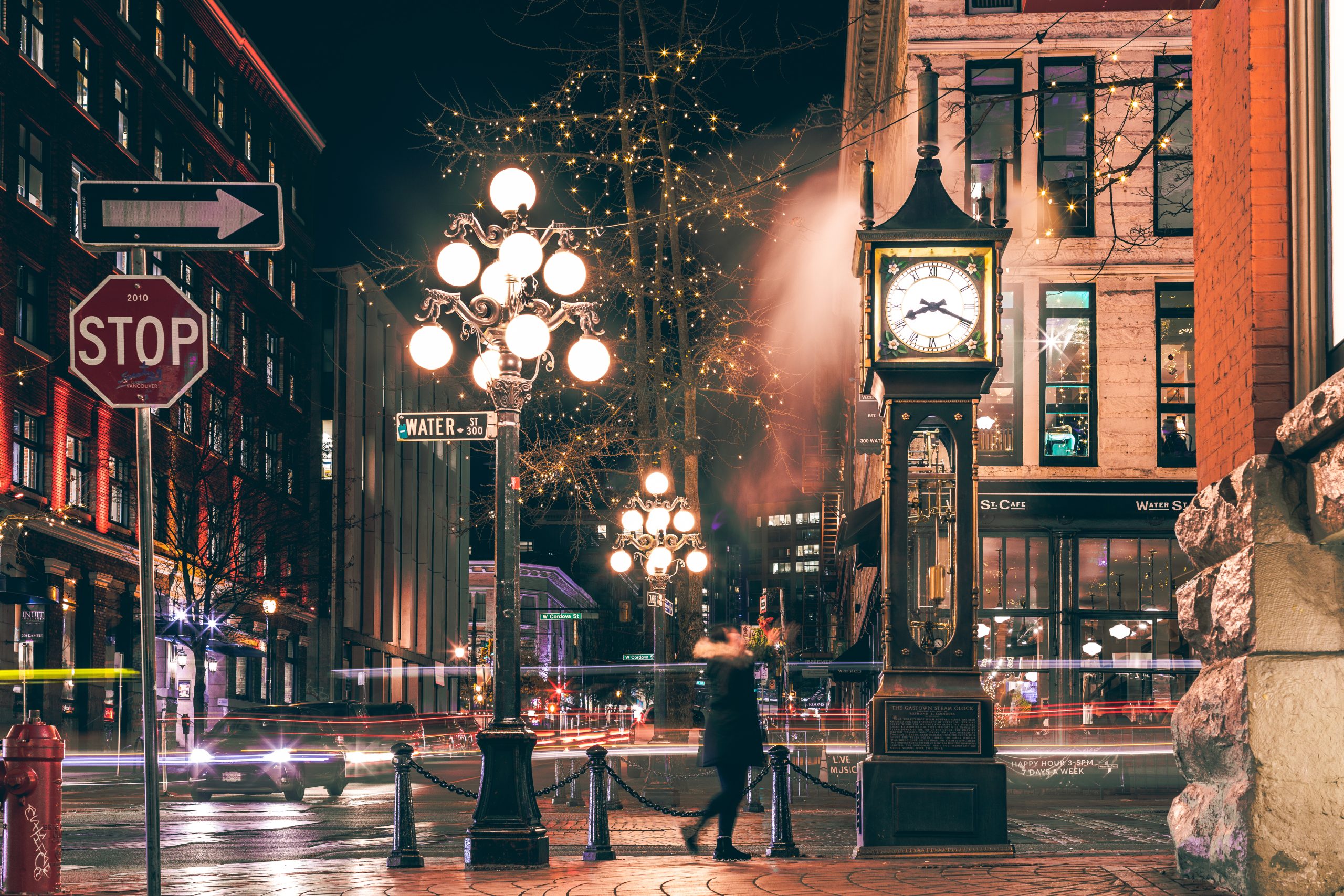 Vancouver, British Columbia - Dec 3, 2019 : The famous Steam Clock in Gastown in Vancouver city with cars light trails at night